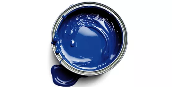 Top‑down view of an open paint can filled with smooth blue paint on a clean white background. The image highlights color intensity, texture, and fluidity, conveying themes of coatings performance, color science, material formulation, and industrial innovation.