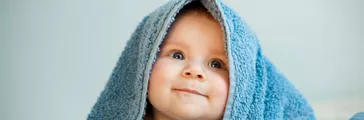 Funny little girl in blue towel
