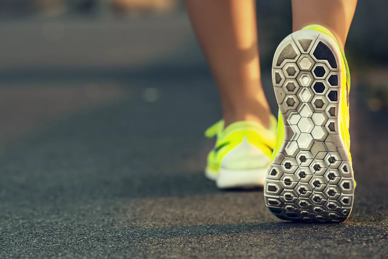 Neon yellow shoes in running position 