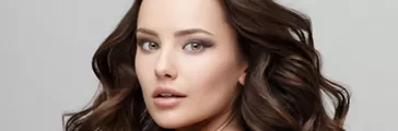 Young woman with curled hair and bare back