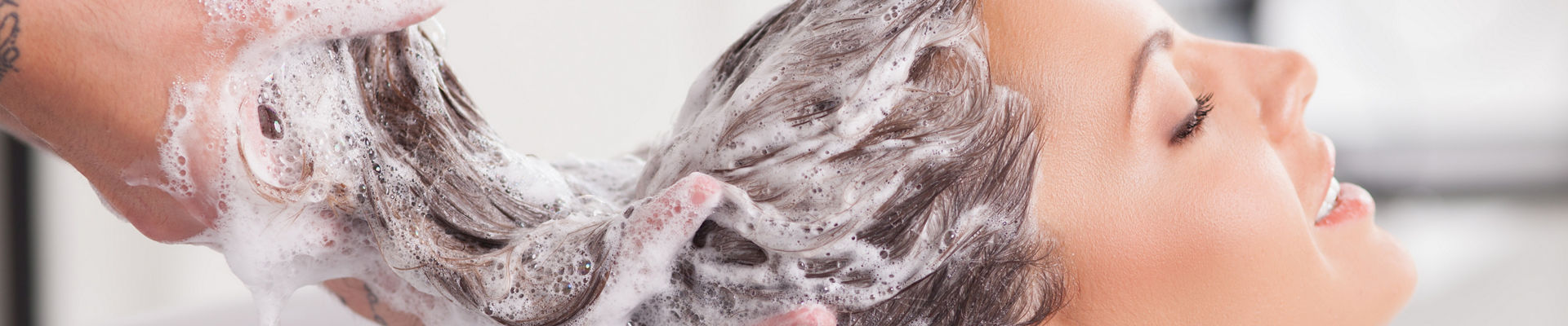 Close up of woman getting hair shampooed
