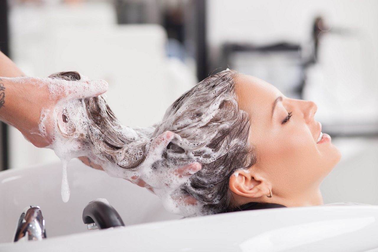 Close up of woman getting hair shampooed
