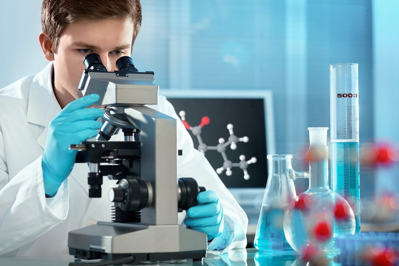 Scientist looking through a microscope